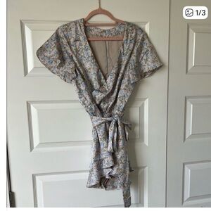 Never worn. New with tags. Show Me Your MuMu Blue Floral Wrap Romper